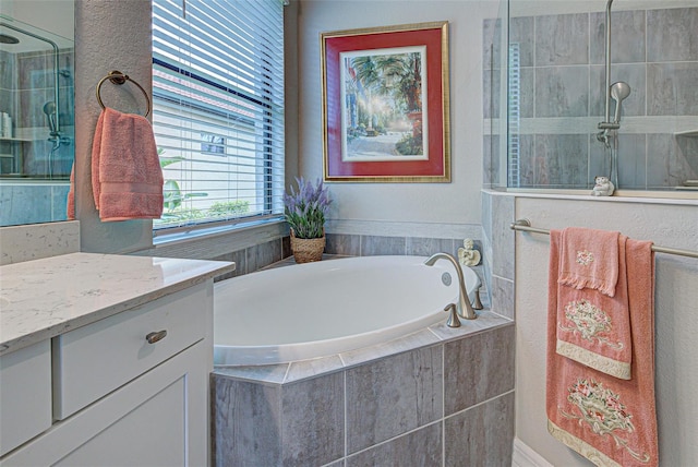 full bathroom with a garden tub, a tile shower, and vanity