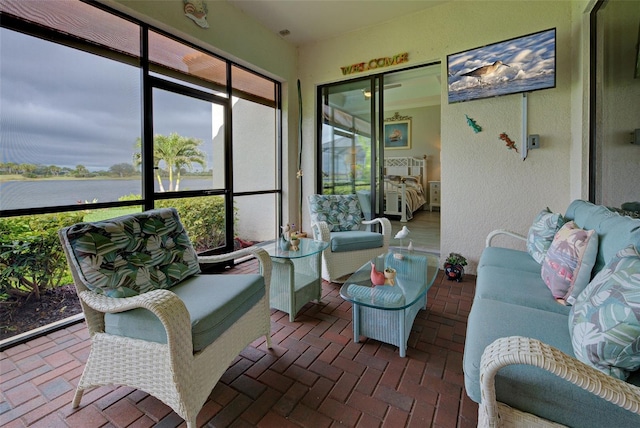 sunroom / solarium with a healthy amount of sunlight and a water view