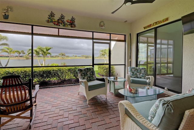 sunroom with a water view and a ceiling fan