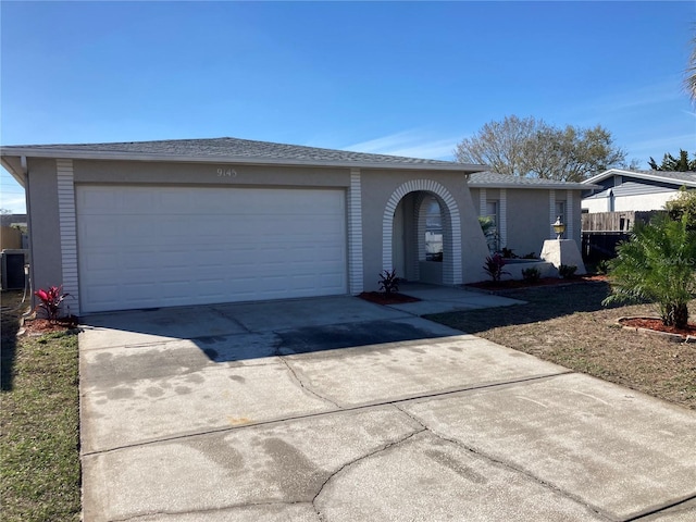 ranch-style home with driveway and an attached garage