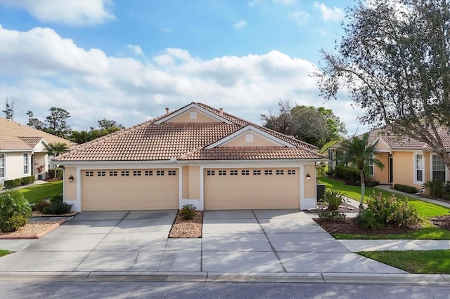 view of front of property featuring a garage, driveway, a tile roof, and stucco siding