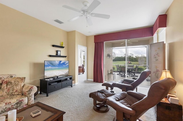 living room featuring a ceiling fan, light colored carpet, visible vents, and baseboards