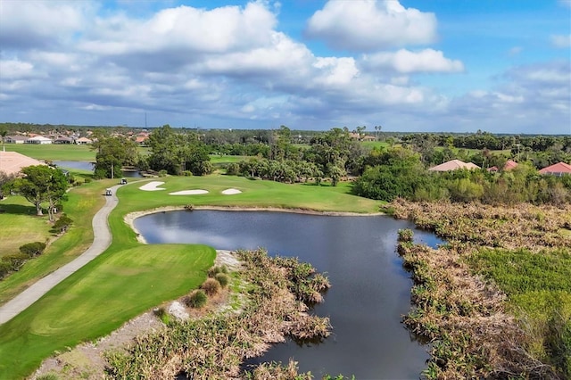 drone / aerial view with golf course view and a water view