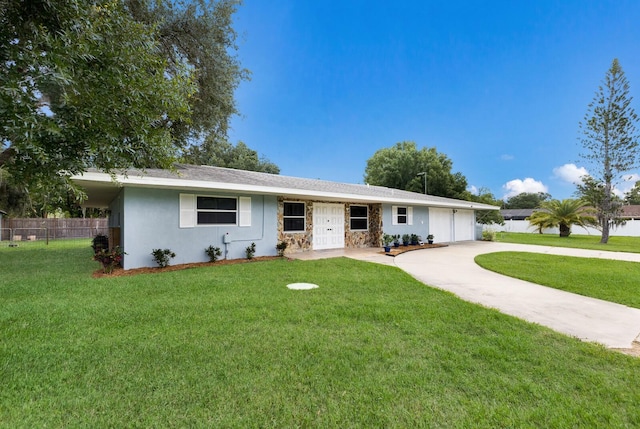 single story home featuring stucco siding, concrete driveway, an attached garage, a front yard, and fence