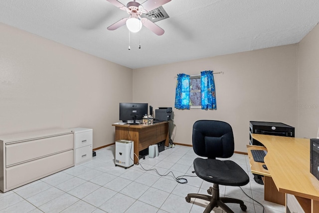 office area with light tile patterned floors, visible vents, a ceiling fan, a textured ceiling, and baseboards