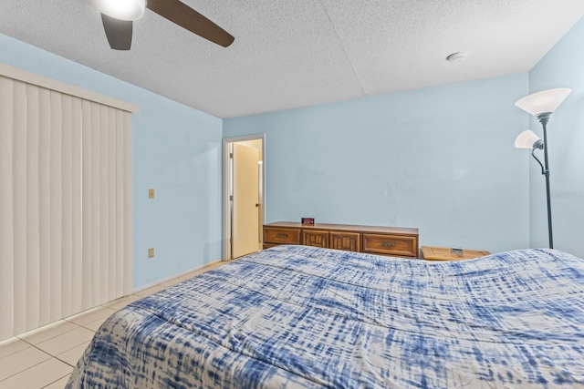 bedroom featuring light tile patterned floors, a textured ceiling, and a ceiling fan