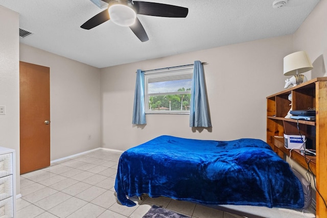 tiled bedroom featuring visible vents, ceiling fan, a textured ceiling, and baseboards