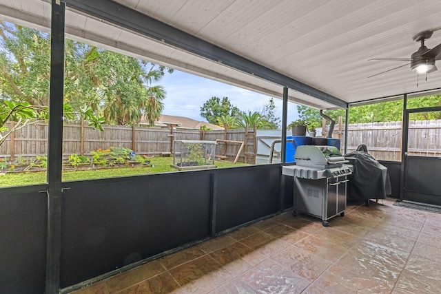 unfurnished sunroom with ceiling fan