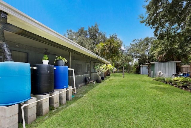 view of yard with a ceiling fan and fence