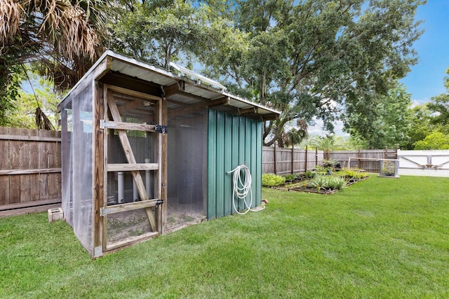 view of outbuilding with a fenced backyard and an outdoor structure