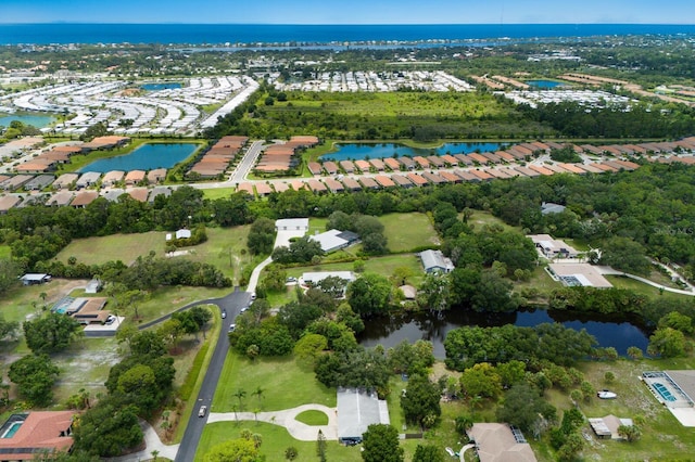 birds eye view of property with a water view and a residential view