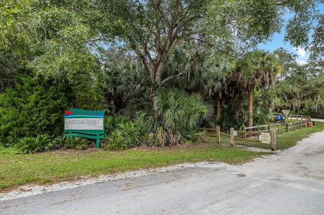 view of home's community featuring fence