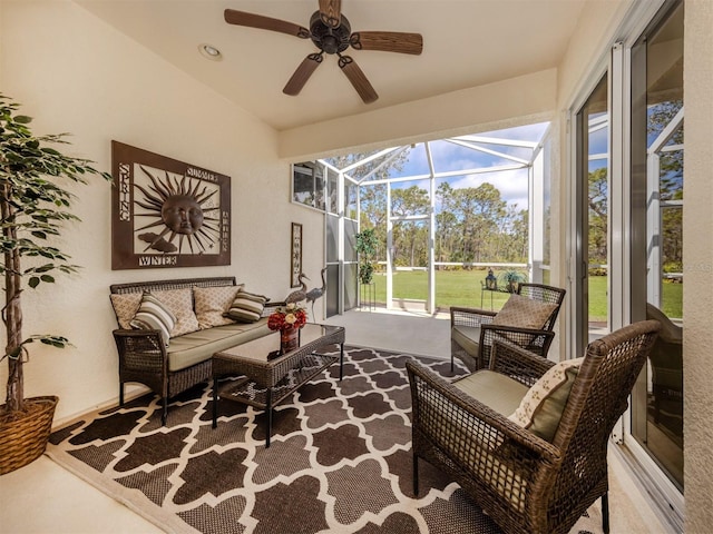 living room with lofted ceiling, a sunroom, and a ceiling fan