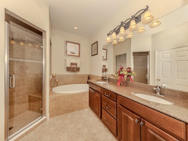 full bathroom with a stall shower, a sink, and tile patterned floors