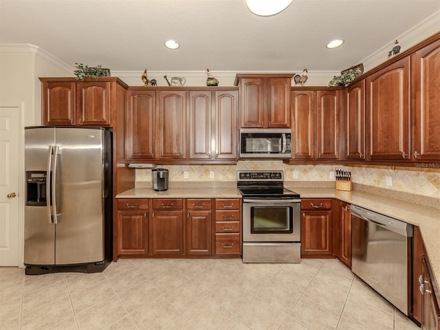 kitchen with light tile patterned floors, light countertops, ornamental molding, appliances with stainless steel finishes, and tasteful backsplash