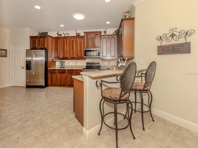 kitchen with tasteful backsplash, a peninsula, stainless steel appliances, crown molding, and light countertops