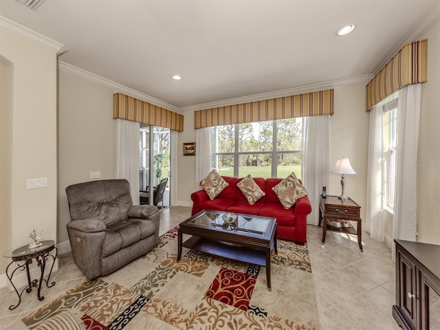 living room with light tile patterned floors, ornamental molding, recessed lighting, and a healthy amount of sunlight