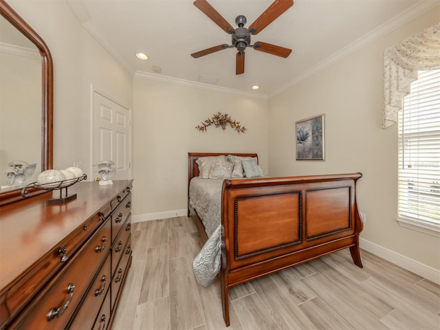 bedroom with light wood finished floors, multiple windows, baseboards, and ornamental molding