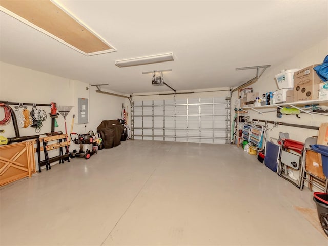 garage featuring electric panel and a garage door opener