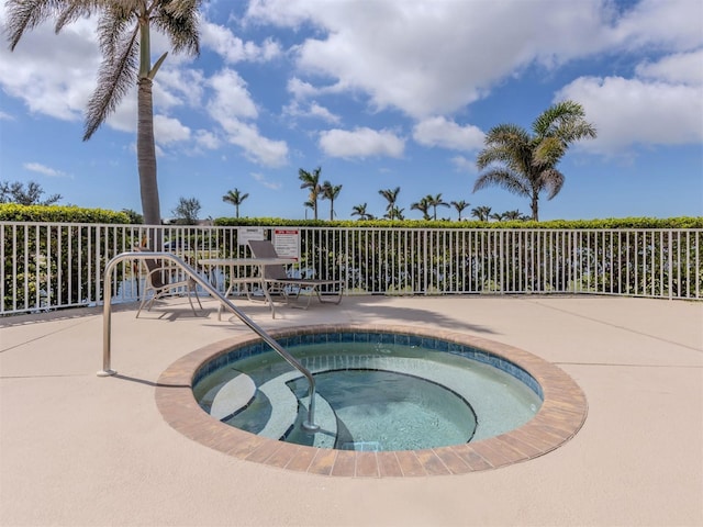 view of pool featuring a hot tub and a patio