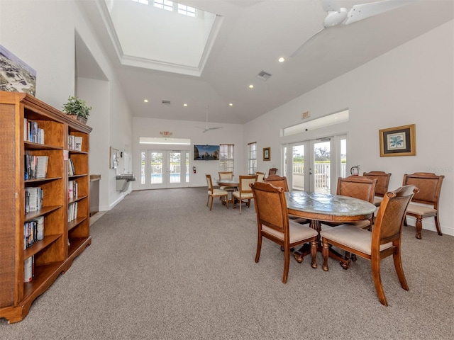 dining area featuring french doors, a healthy amount of sunlight, and light colored carpet