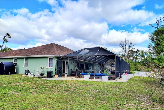 23495 Altman Ave, Punta Gorda, FL 33980 - rear view of house featuring stucco siding, fence, glass enclosure, a yard, and a patio area
