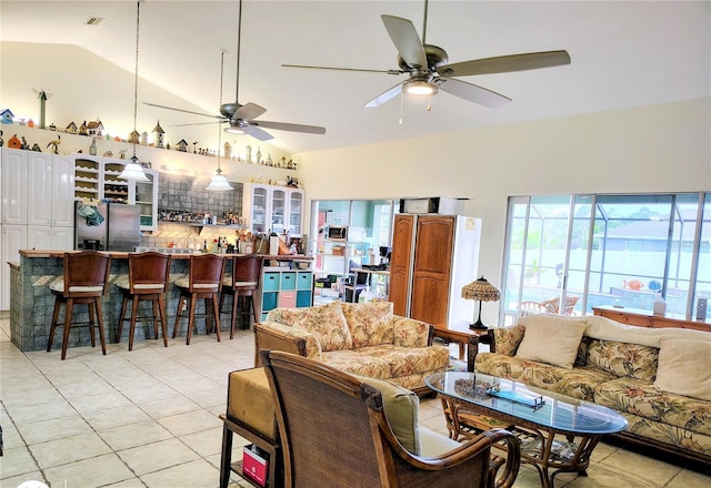 23495 Altman Ave, Punta Gorda, FL 33980 - living area featuring vaulted ceiling, light tile patterned floors, and a ceiling fan