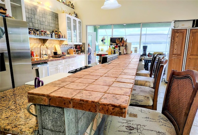23495 Altman Ave, Punta Gorda, FL 33980 - kitchen with white cabinetry, a sink, appliances with stainless steel finishes, and decorative backsplash
