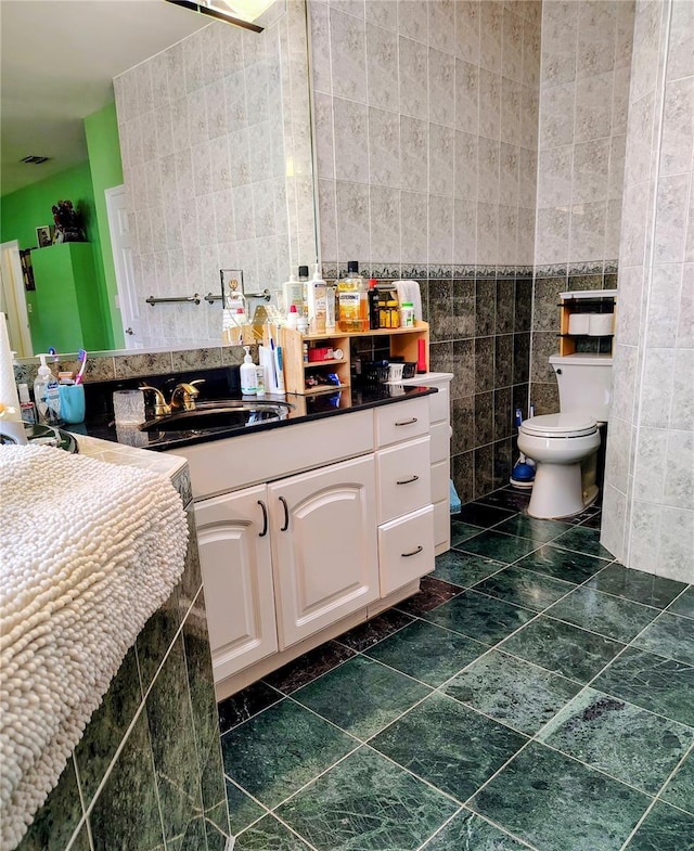 23495 Altman Ave, Punta Gorda, FL 33980 - bathroom featuring tile walls, toilet, and vanity