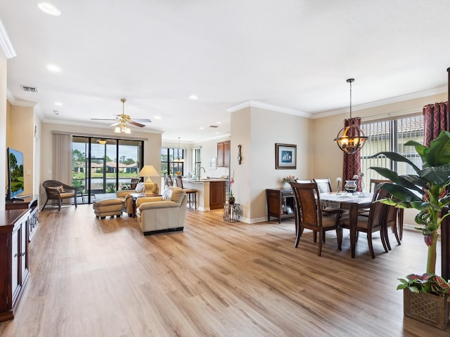 1425 Maseno Dr, Venice, FL 34292 - living room featuring a chandelier, light wood finished floors, crown molding, a ceiling fan, and recessed lighting