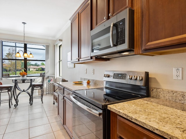 1425 Maseno Dr, Venice, FL 34292 - kitchen with stainless steel appliances, a chandelier, crown molding, brown cabinetry, and light tile patterned floors