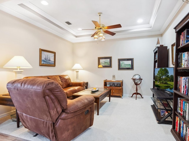 1425 Maseno Dr, Venice, FL 34292 - living area with ornamental molding, ceiling fan, a tray ceiling, baseboards, and light colored carpet