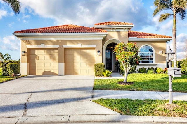 mediterranean / spanish-style home featuring a garage, driveway, a front lawn, and stucco siding