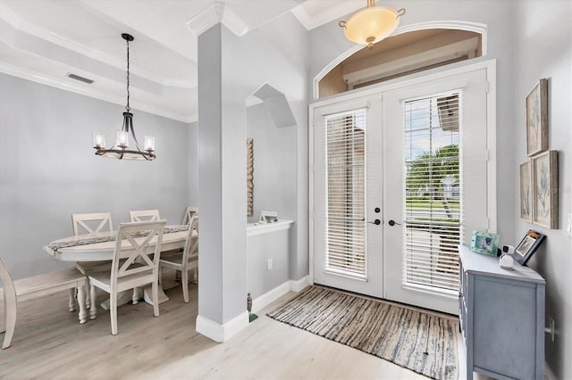 entrance foyer with french doors, visible vents, crown molding, and light wood finished floors