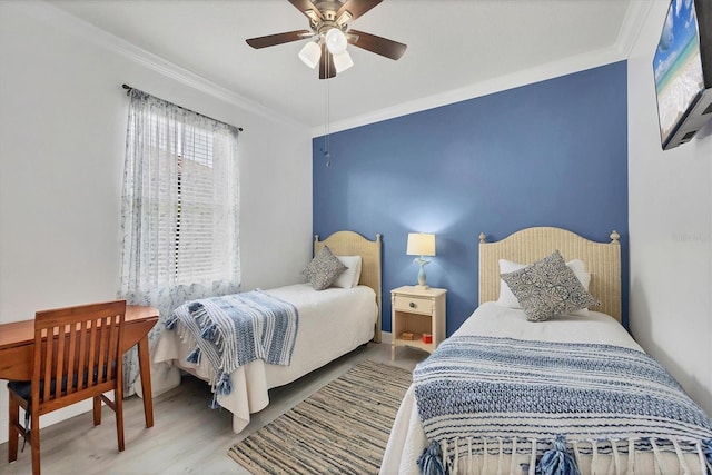 bedroom featuring ceiling fan, ornamental molding, and wood finished floors