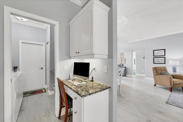 home office with light wood finished floors, baseboards, crown molding, and built in study area