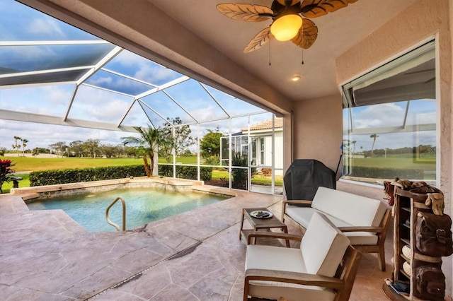 pool with glass enclosure, a patio, and ceiling fan