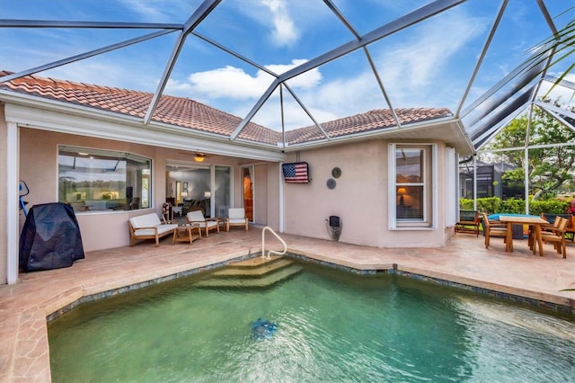 outdoor pool featuring a lanai and a patio area