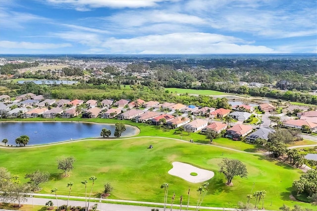 drone / aerial view featuring a water view, view of golf course, and a residential view