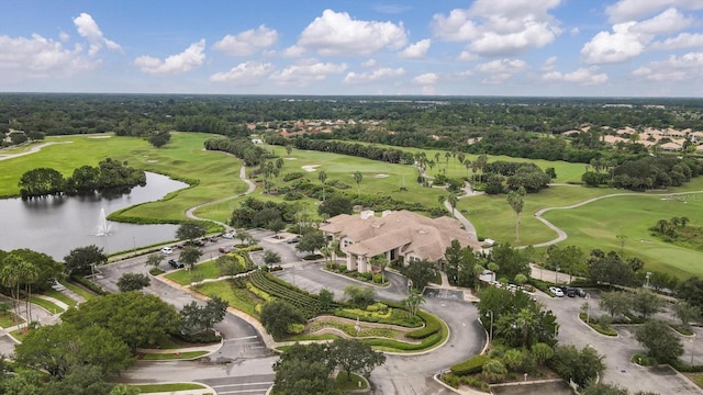 drone / aerial view with a water view and golf course view