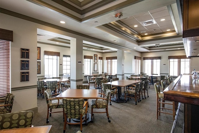 carpeted dining space featuring ornamental molding, a tray ceiling, visible vents, and recessed lighting