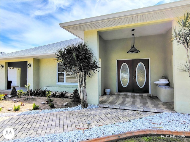 doorway to property with stucco siding