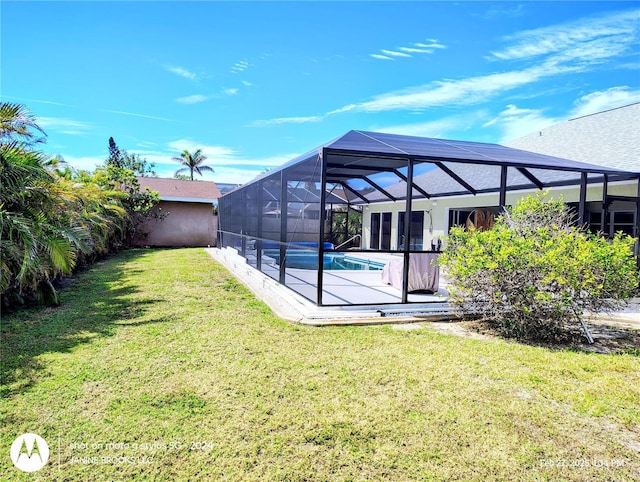 rear view of property with a lanai, a yard, an outdoor pool, a carport, and a patio area