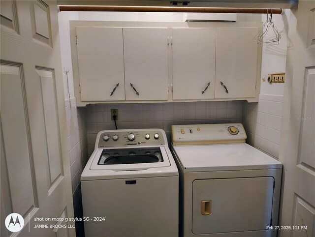 laundry room with cabinet space and washing machine and clothes dryer