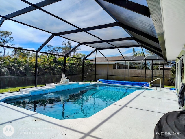 view of swimming pool featuring a patio, a lanai, and a fenced in pool