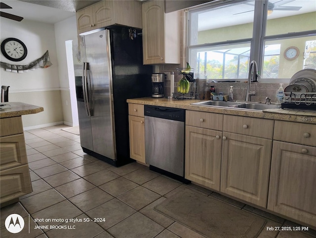 kitchen with light brown cabinets, stainless steel appliances, a sink, a ceiling fan, and light countertops