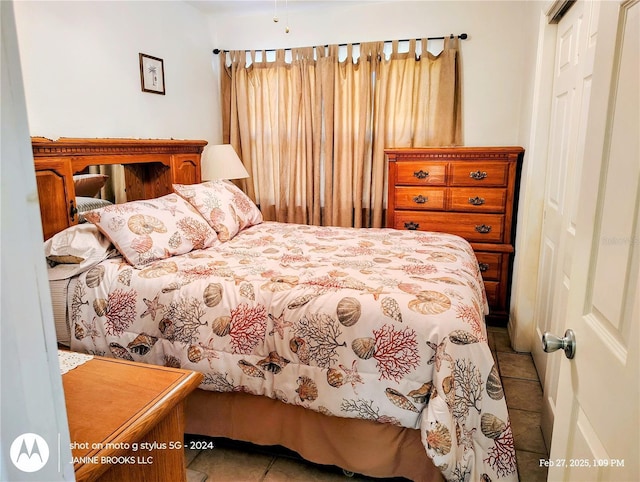 bedroom with a closet and tile patterned floors