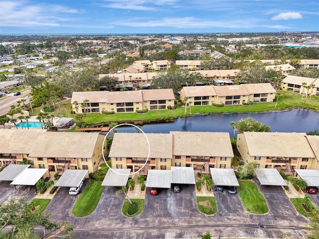 drone / aerial view with a water view and a residential view