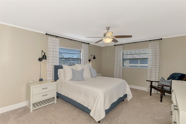 bedroom with light colored carpet, crown molding, baseboards, and multiple windows