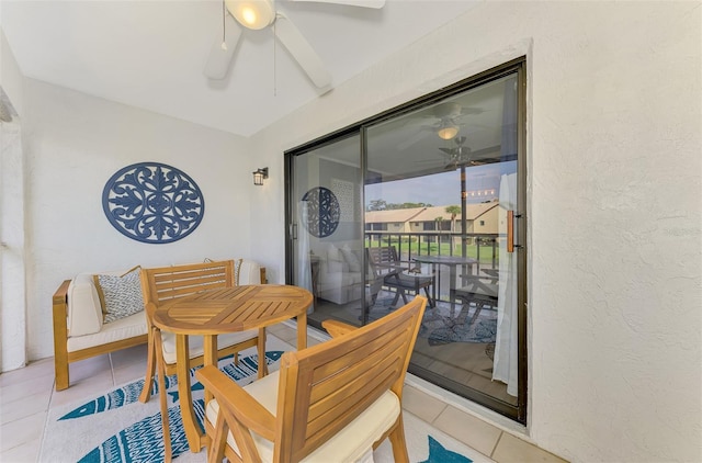 dining area with a ceiling fan, a textured wall, and light tile patterned floors